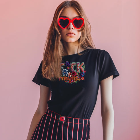 Black unisex T-shirt with bold floral embroidery-style text reading "F*ck Tyrants" in vibrant colors.